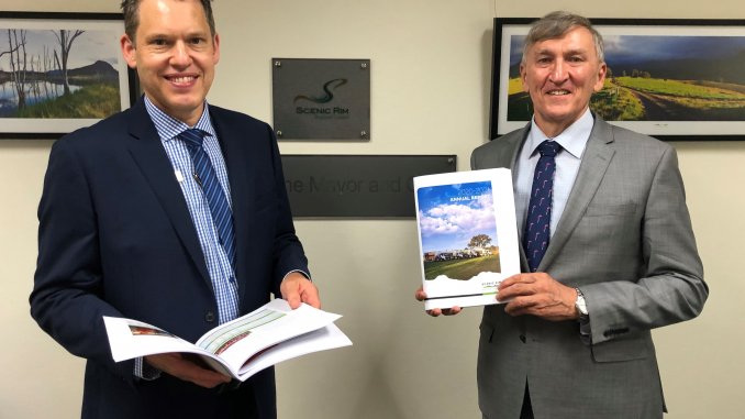 Jon Gibbons with Mayor Greg Christensen and Council’s 2020-21 Annual Report. Photo: Scenic Rim Regional Council.