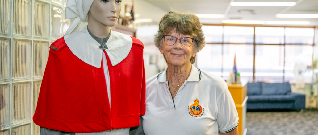 Beaudesert RSL Sub-Branch President Carol Castles with an example of an historic Australian Army nursing uniform.