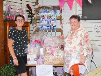Bean To owner, Kylie Peterson with Kerrie Wise from Cancer Council Beaudesert Branch and the many raffle prizes donated by local businesses.