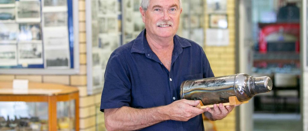 Beaudesert Historical Society President, Mark Plunkett with the thermos which was instrumental in keeping the Stinson crash survivors alive.