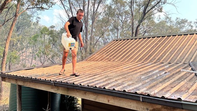 Harper Saxe pours water on the roof