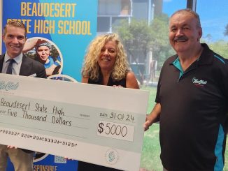 Beaudesert State High School Principal Damien Burke accepts the donation from The Club CEO Sharon Cullen and President Glen Sainty.