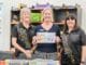 Chaplain Anna Nutley (centre) receives the donation from A Choired Taste's Karen Hardgrave and Jo Rose.